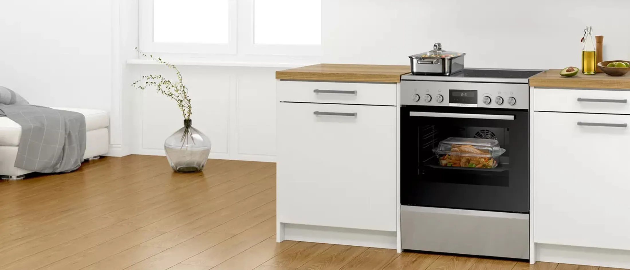 Bosch freestanding cooker in a white and wood kitchen. 