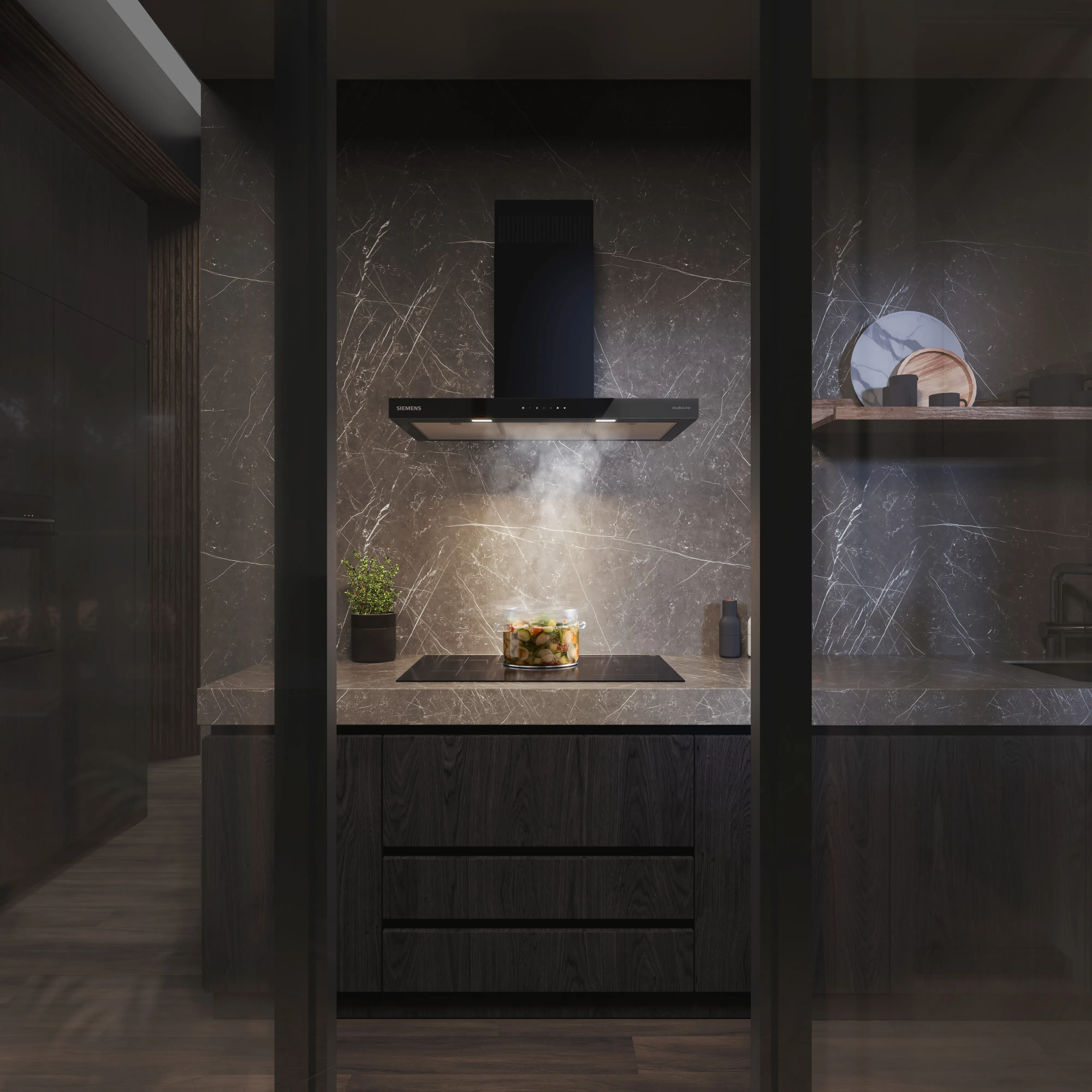 Modern black kitchen with a sleek angled range hood extracting steam from a pan on the dark countertop.
