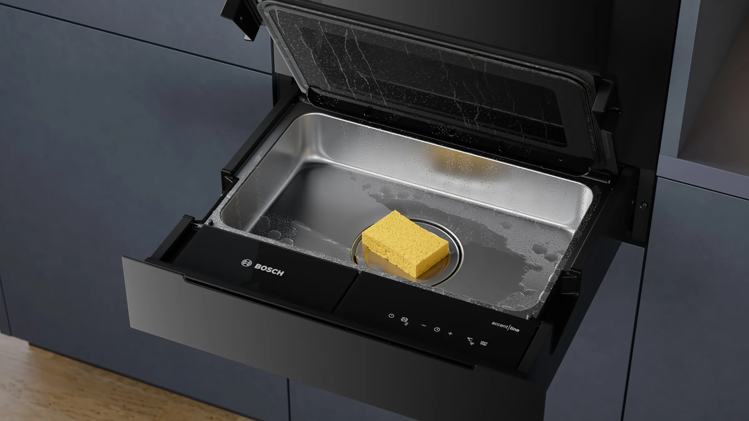 Geöffnete Bosch accent line Dampf-Schublade mit einem gelben Schwamm im Edelstahl-Garraum zur Veranschaulichung der leichten Reinigung.