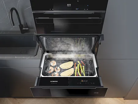 Siemens studioLine steam oven with shrimp, fish, and vegetables cooking on a tray inside.