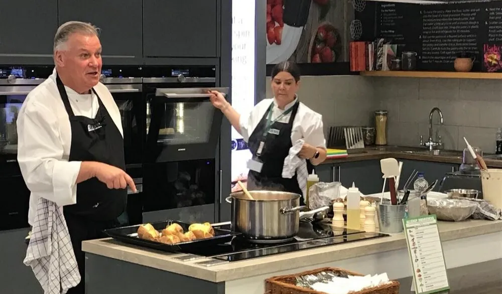 Chefs cooking in Bosch showroom kitchen