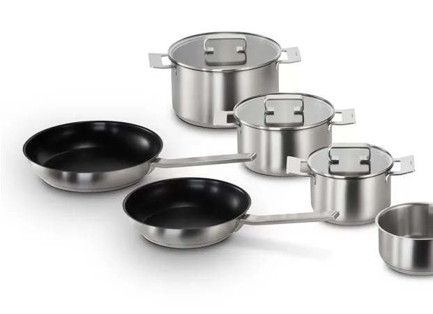 Set of stainless steel cookware with lids, featuring two frying pans and four pots of varying sizes. The image conveys a sleek and modern kitchen vibe.
