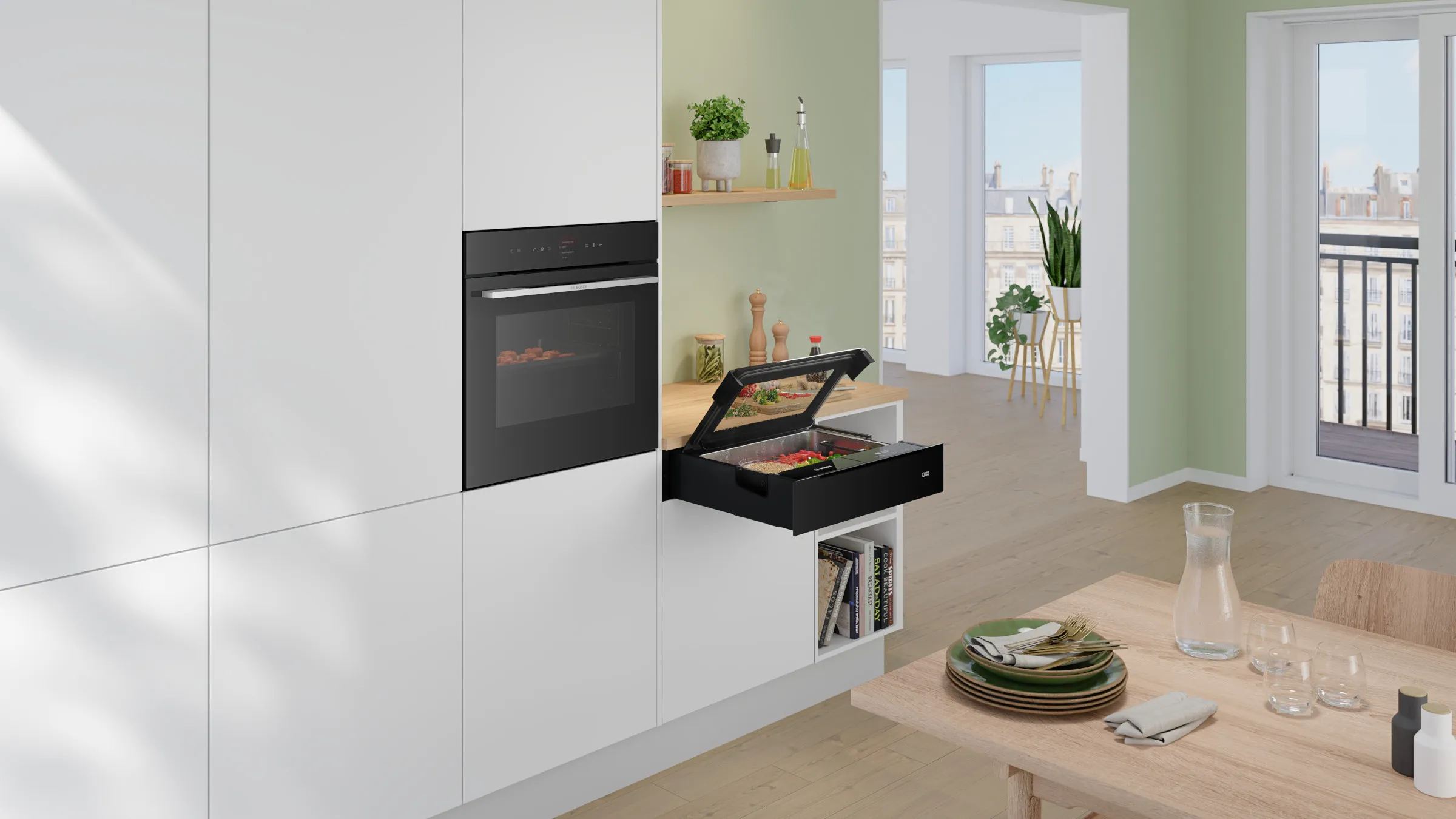 Moderne, helle Einbauküche mit einem integrierten schwarzen Bosch Serie 8 Backofen und einer daneben geöffneten Dampfgarer-Schublade