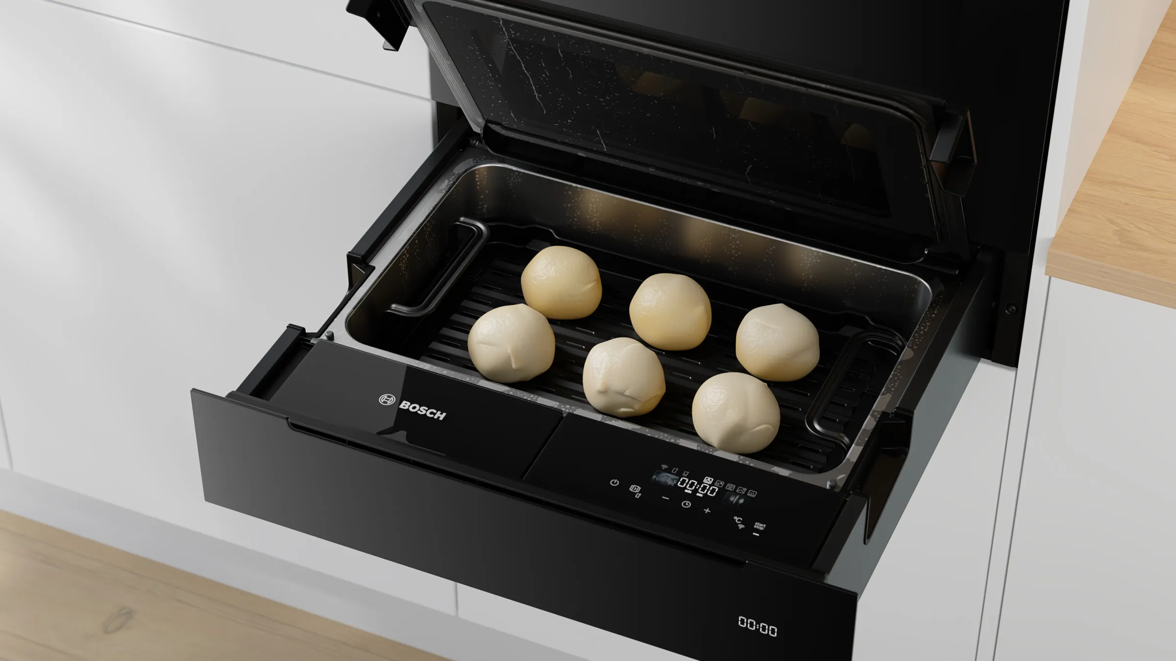 Nahaufnahme der geöffneten Bosch Serie 8 Dampfgarer-Schublade mit sechs rohen Teiglingen (z.B. für Dampfnudeln oder Hefeklöße) im Inneren.