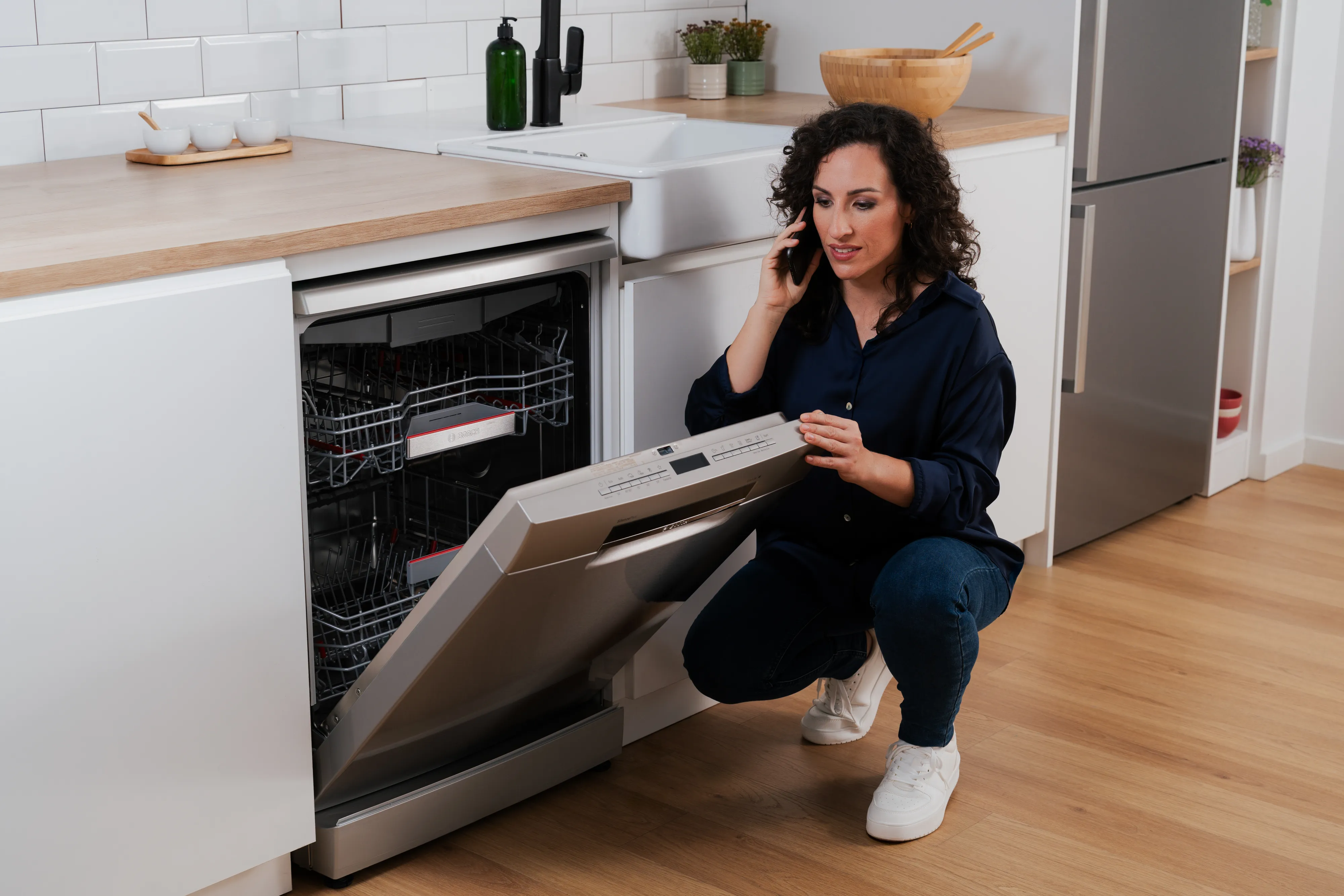 Laptop und Tablet mit Bosch Waschmaschine Informationen in einem modernen Zuhause.