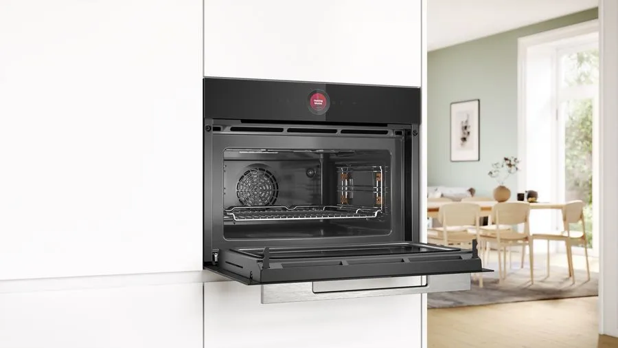 Microwave with grill and automatic settings, offering convenience with special defrost programmes for various food types.