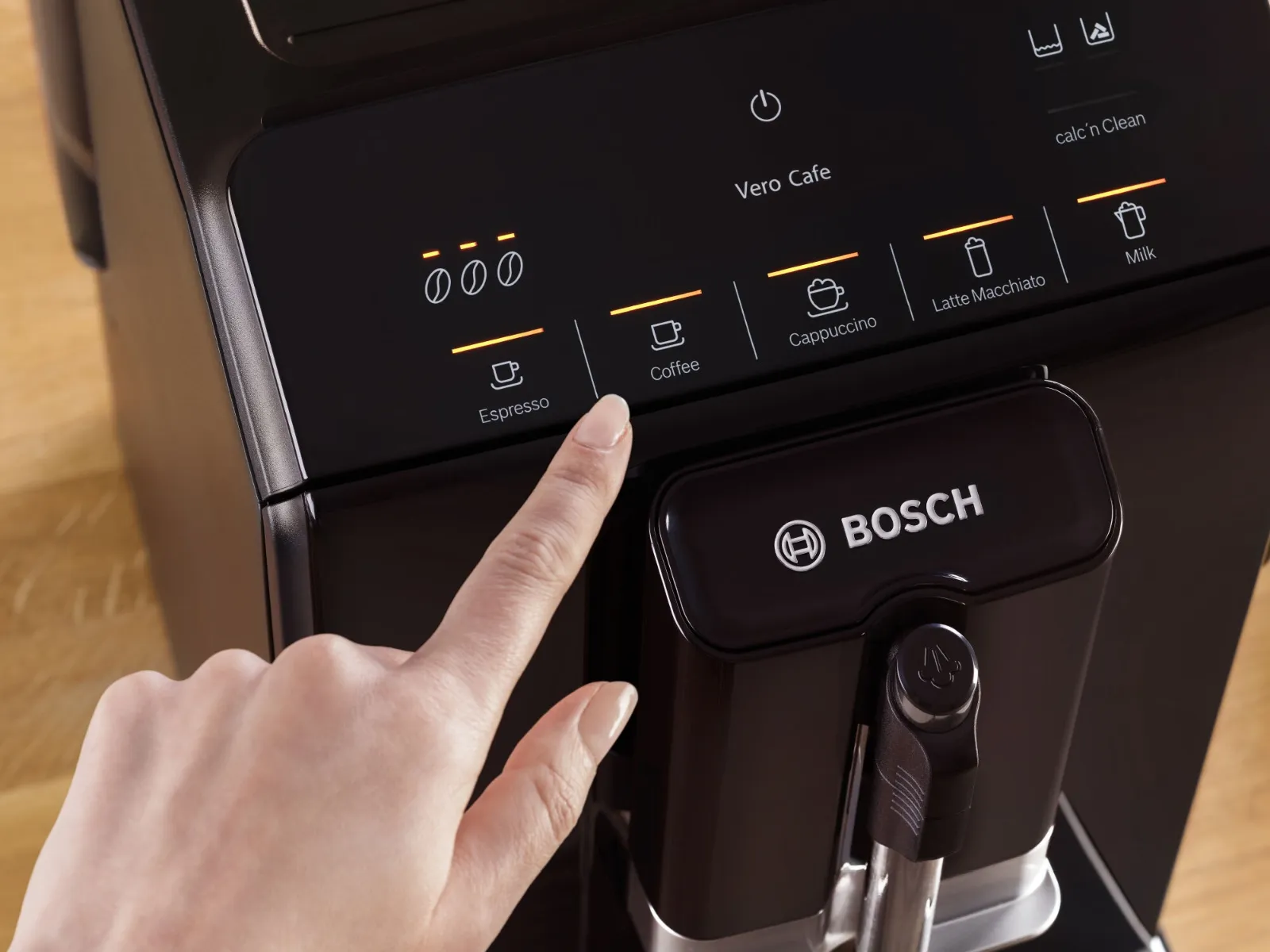 Bird's eye view of VeroCafe coffee machine's Comfort Select Display and a cup of latte macchiato.