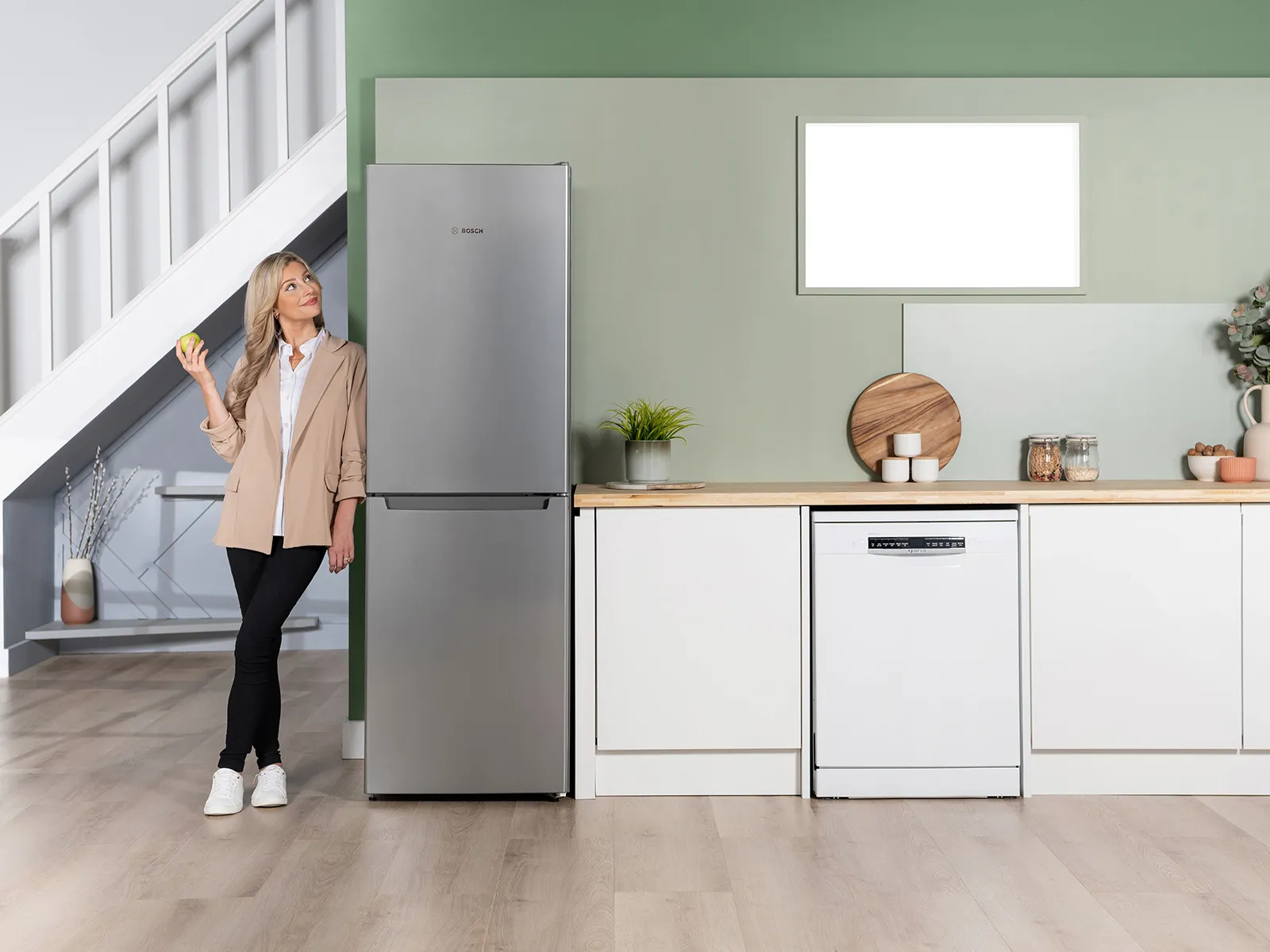 Person stood next to fridge freezer