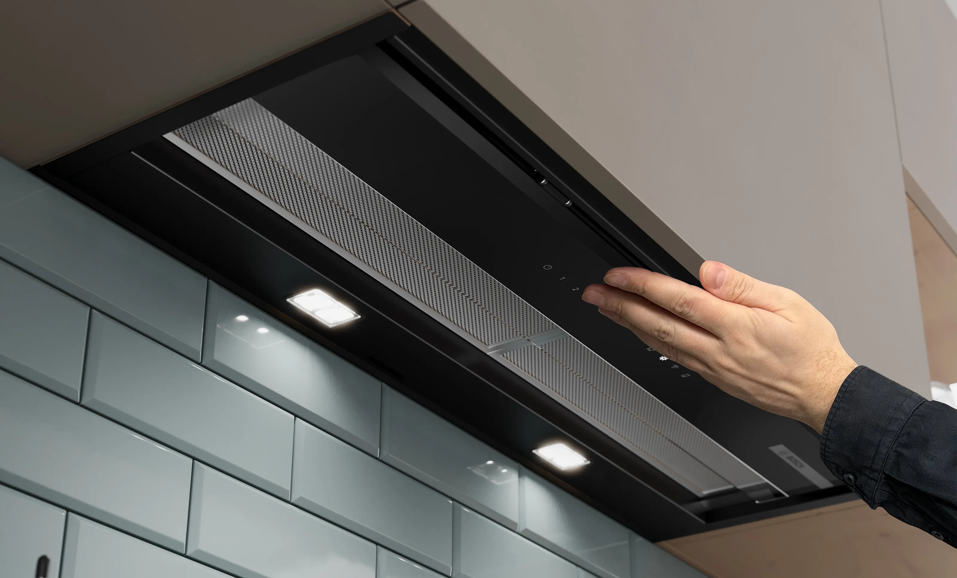 View from below of the Integrated Design Hood, hand tapping on the folded in glass to switch on the Touch Light.