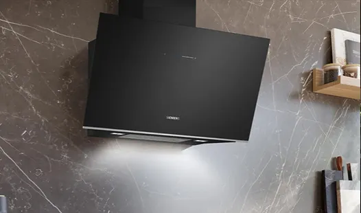 A sleek modern kitchen featuring a stylish black hood above the stove, with contemporary cabinetry and appliances.  