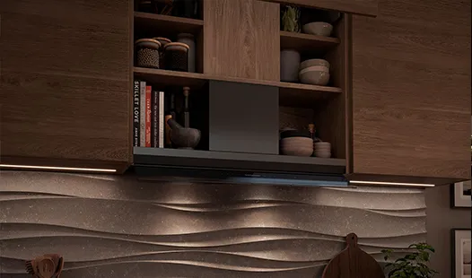 A kitchen featuring a wooden wall, a sink, and an integrated built-in hood above the cooking area.
