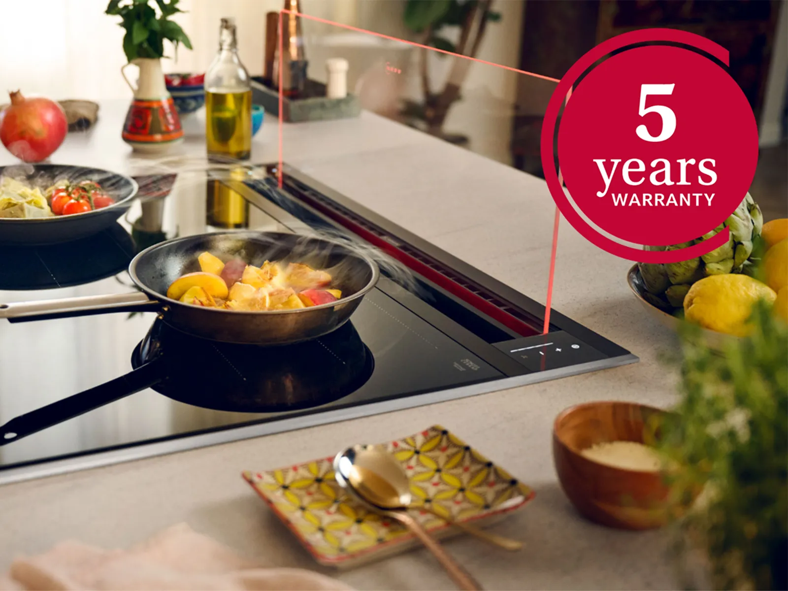 A person cooking on a stove top with a timer, under a glass draft hood, focused on their meal preparation.  