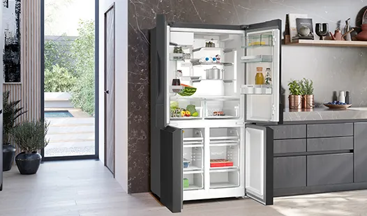 A modern kitchen featuring a sleek refrigerator and a stylish sink, showcasing contemporary design elements.  