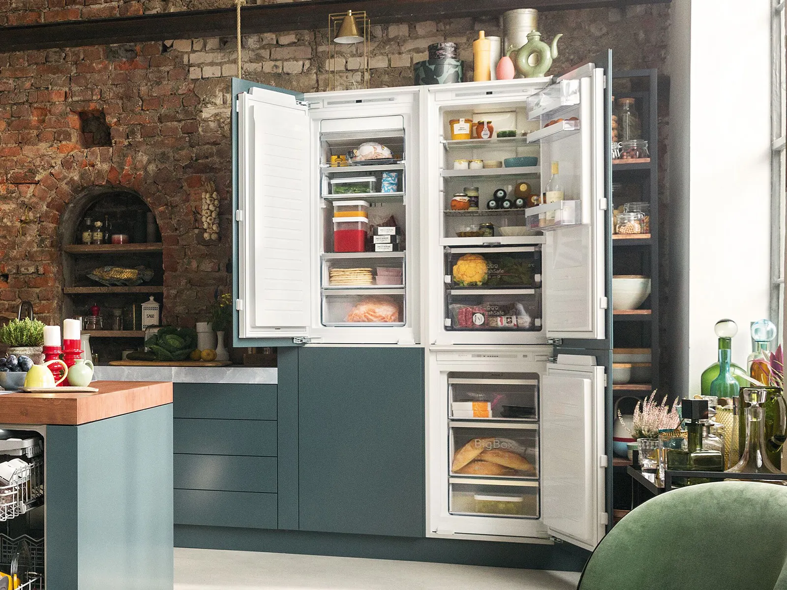 A kitchen featuring a refrigerator and a sink, showcasing a clean and functional cooking space. 