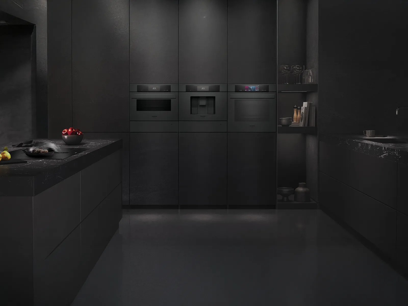 Cucina nera elegante con elettrodomestici integrati, marmo scuro e vivaci mele rosse, che incarna l'eleganza moderna.