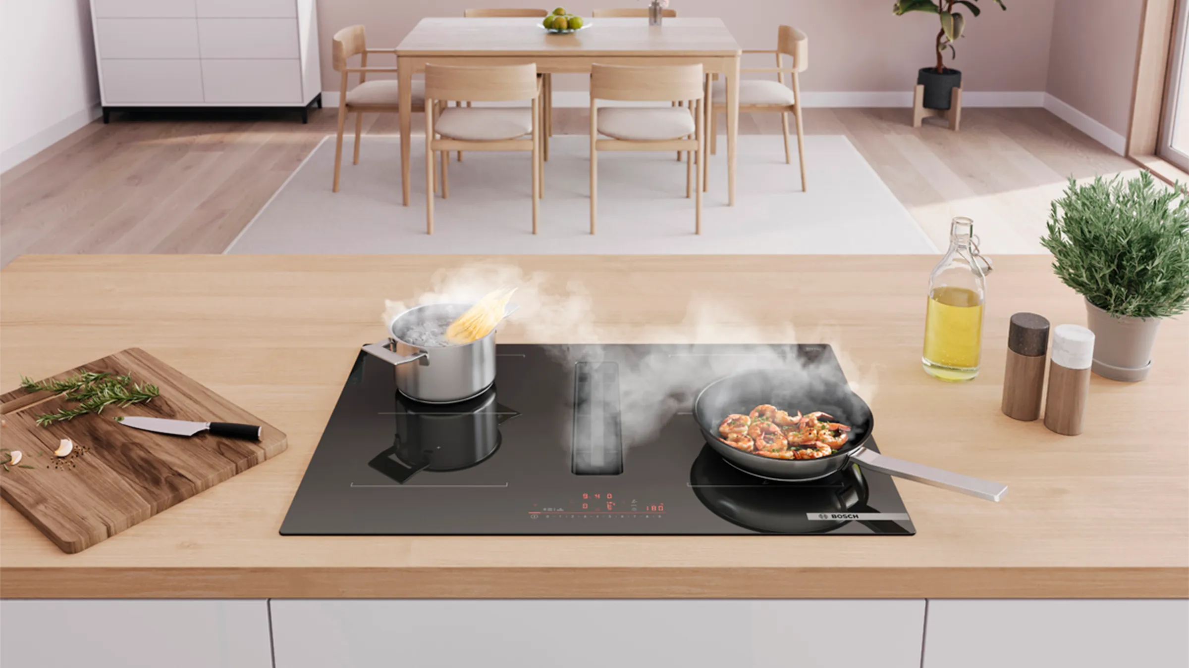 Modern kitchen with an induction cooktop cooking pasta and shrimp, with spices and oil nearby.