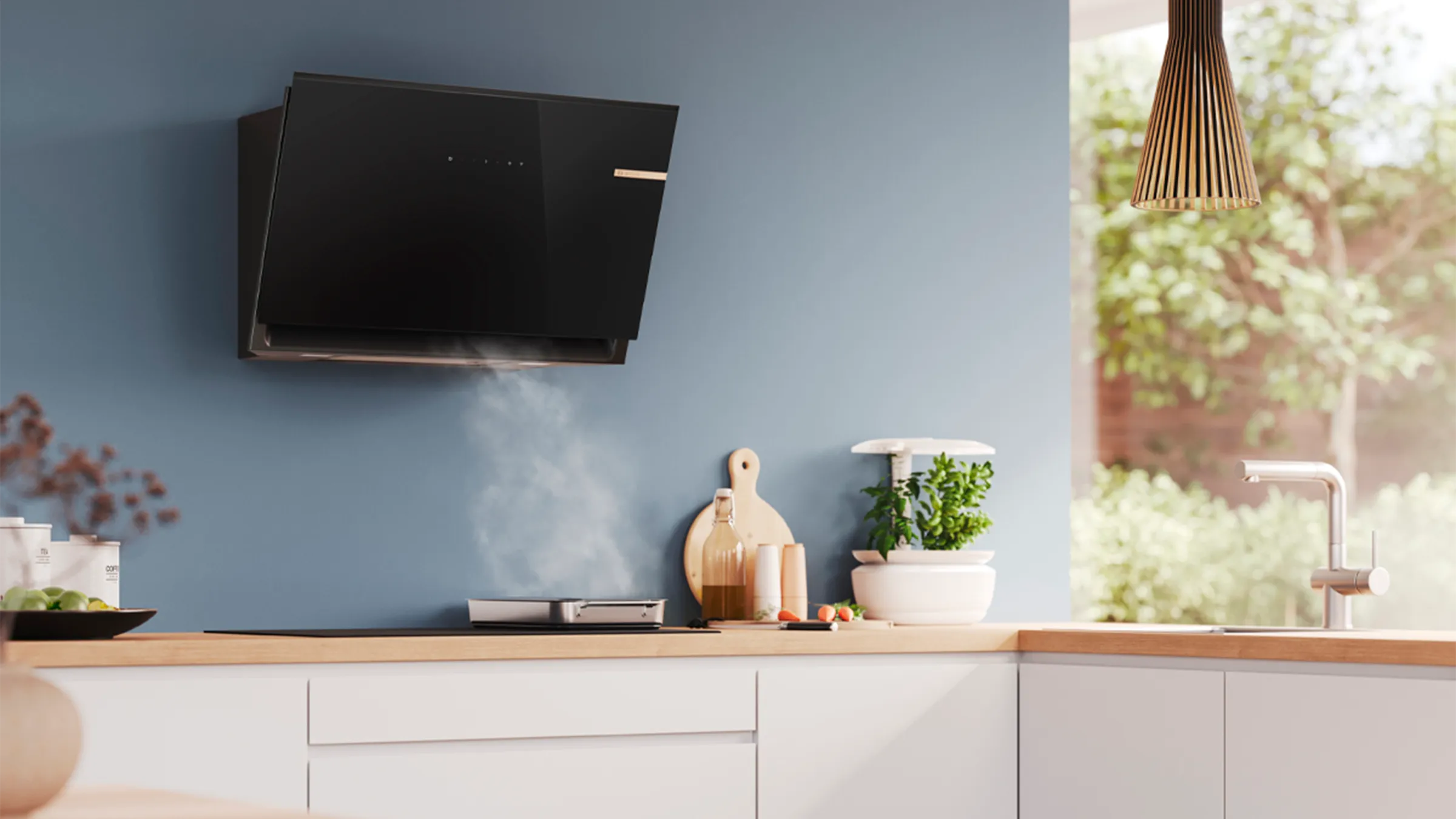 Modern kitchen with a sleek black wall-mounted range hood above a stove on a wooden counter.