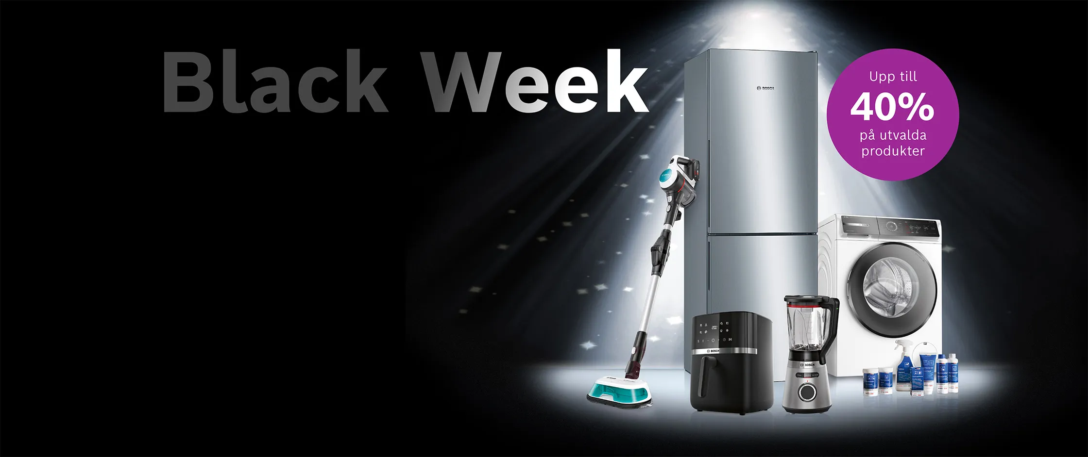 Black weeks - svart bakgrund, en kyl-frys, unlimited-dammsugare, airfryer, blender och en tvättmaskin står ihop under ett ljust sken som lyser ner på produkterna