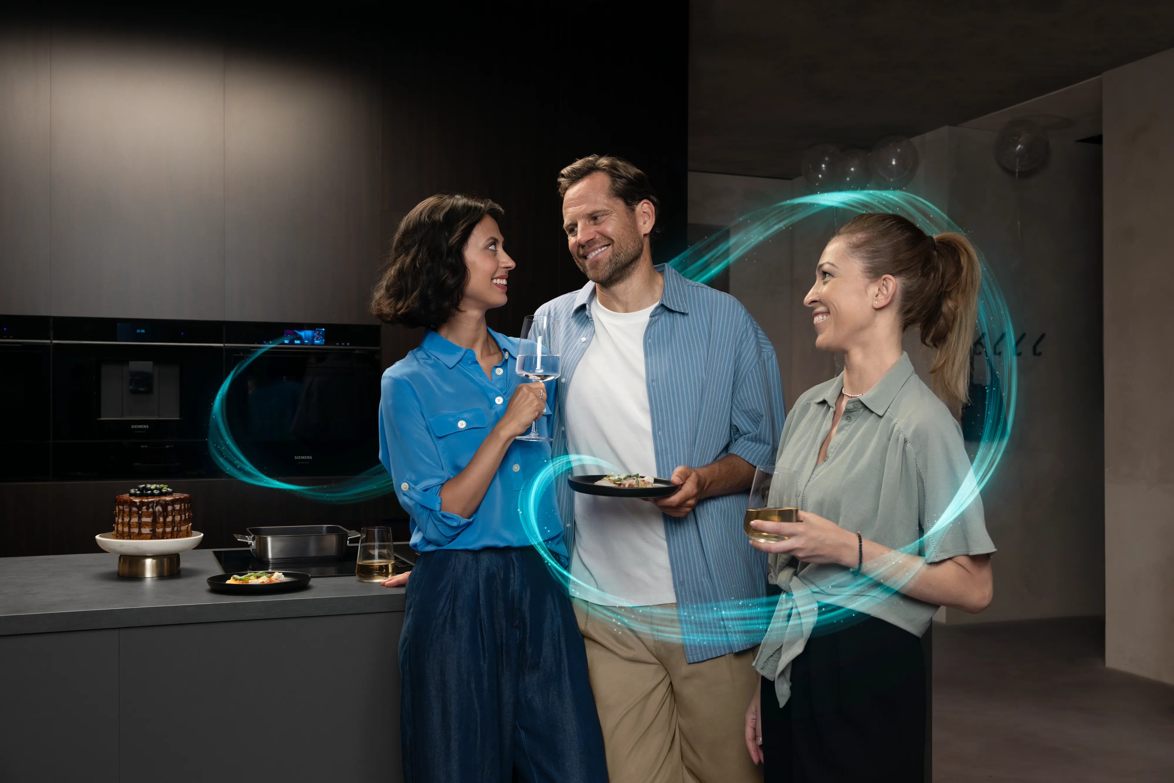 Kitchen scene with people and Siemens oven in the background.