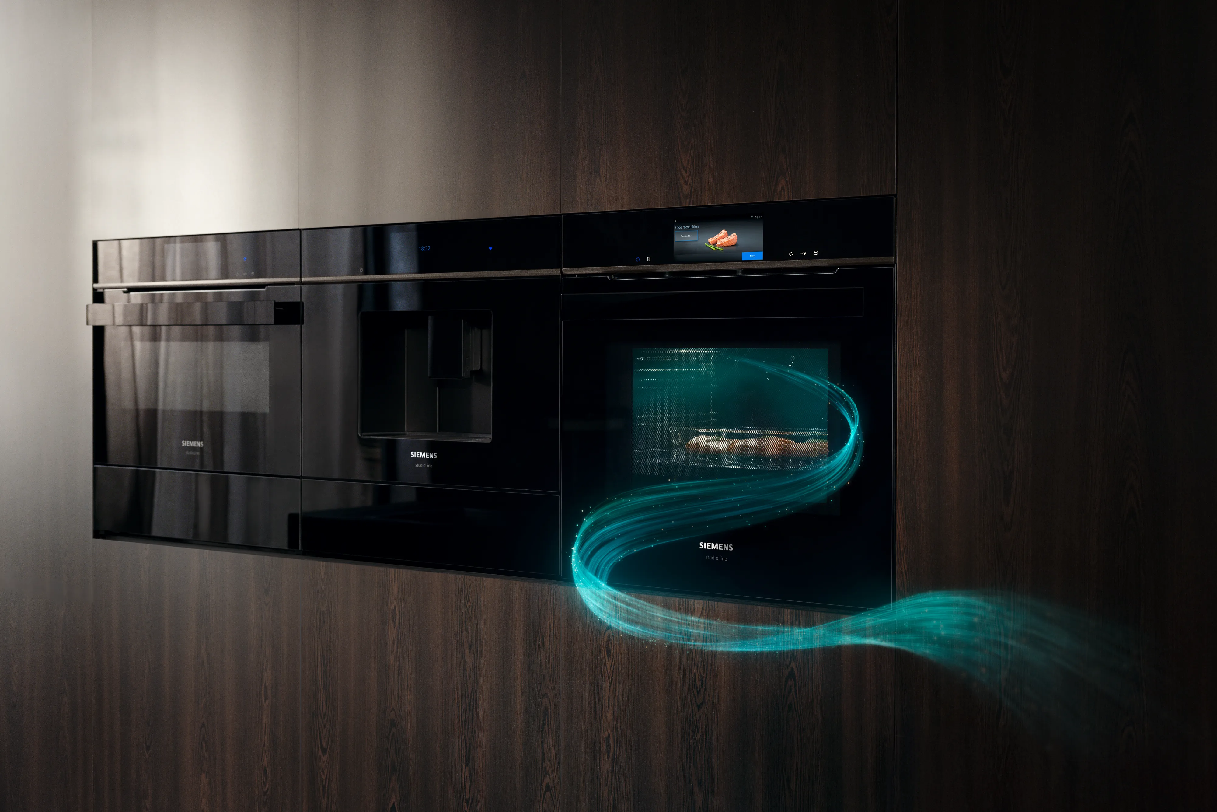 Sleek black kitchen appliances integrated into warm wooden cabinetry, featuring a modern, minimalist design.