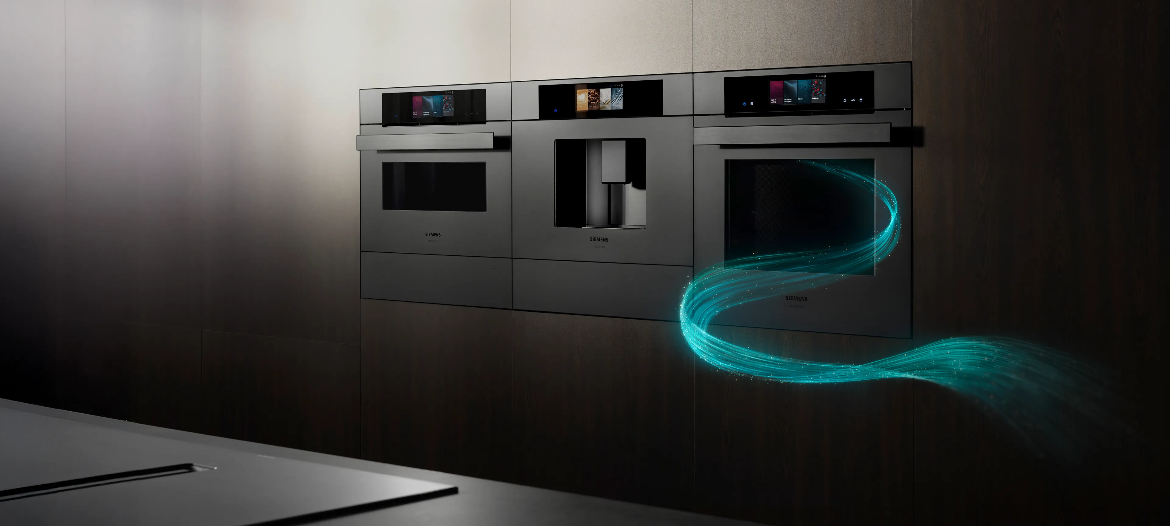 Sleek modern kitchen wall with built-in Siemens appliances including ovens and a coffee machine, accented with a glowing blue swirl graphic.