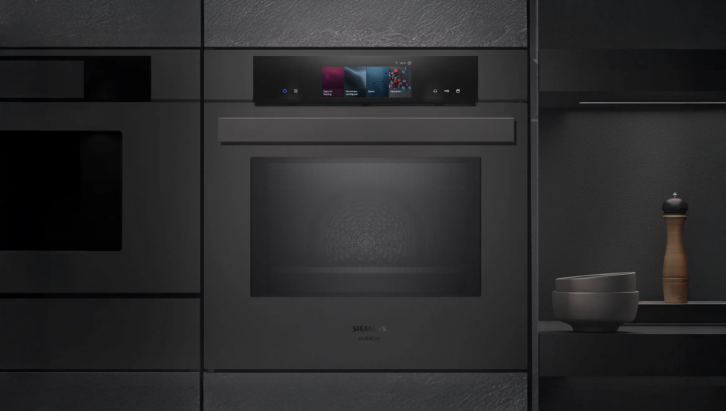 Black oven integrated in a black kitchen