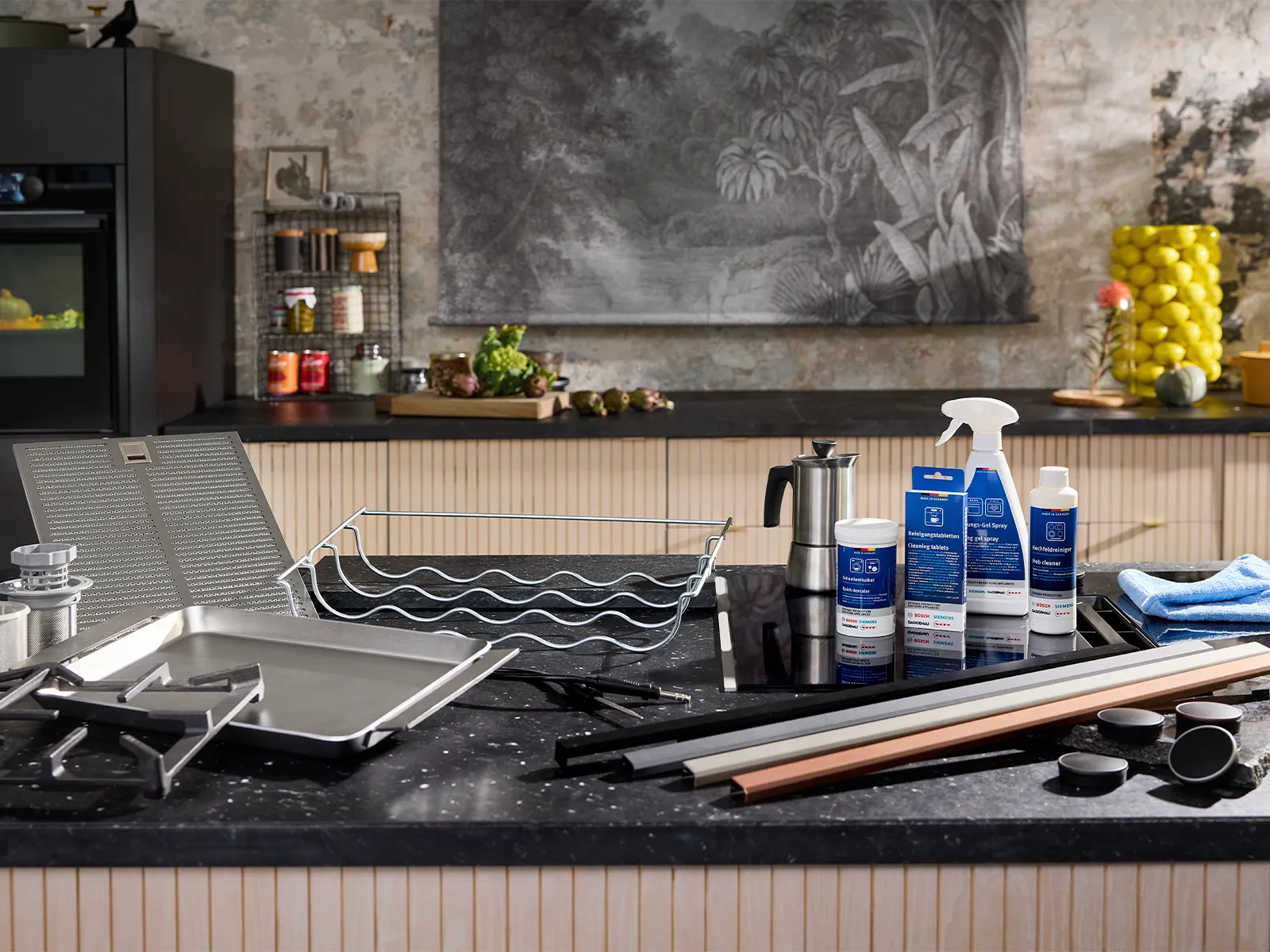 A modern kitchen scene featuring Neff cookware, cleaning products, and utensils on a stylish countertop with vibrant decor in the background.