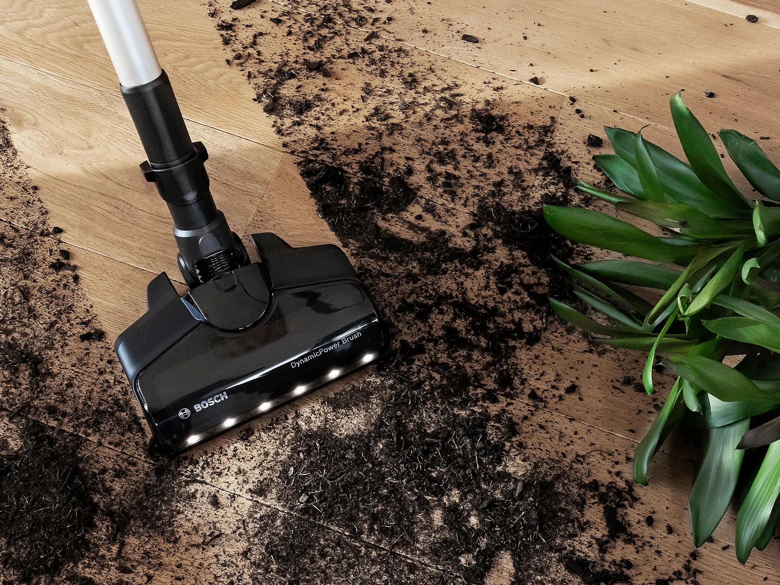 Bosch cordless vacuum with LED lights cleaning up dirt.