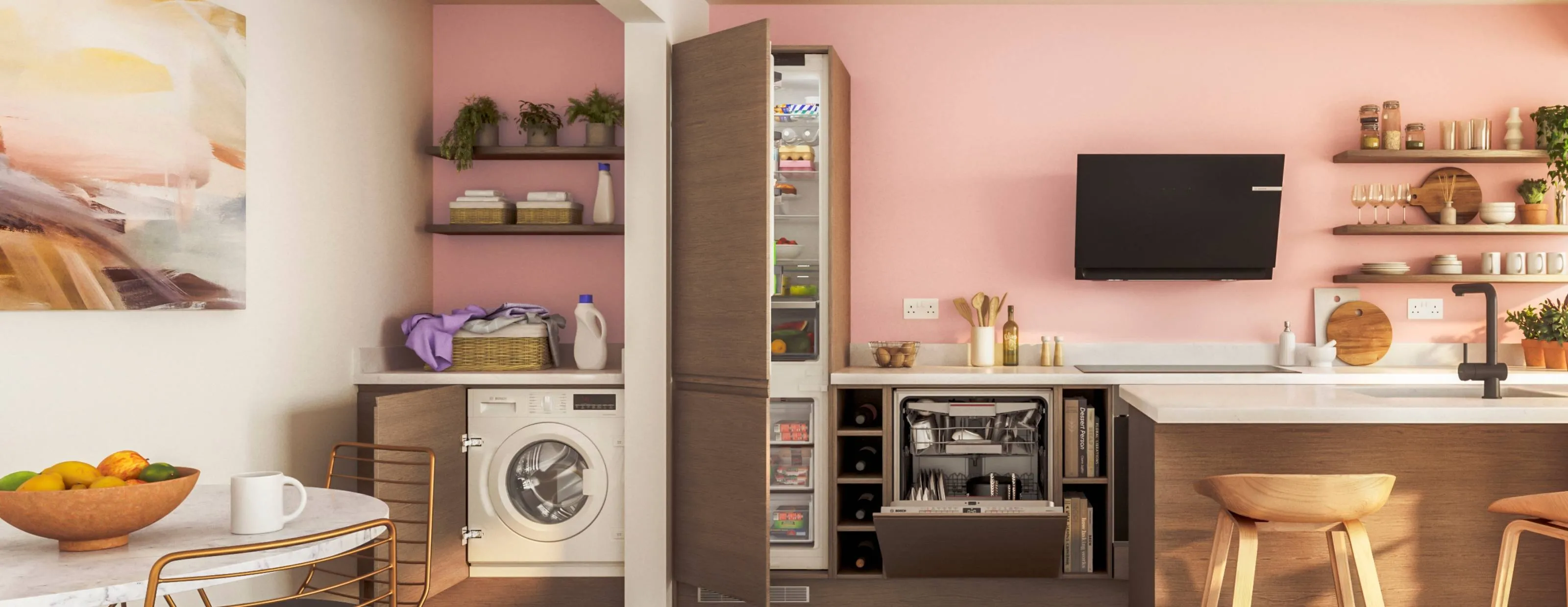 A vibrant, open-plan kitchen and laundry area with pink walls, featuring integrated appliances including a washing machine, a tall refrigerator with its door open, and a dishwasher, alongside a black extractor hood and wooden shelving.