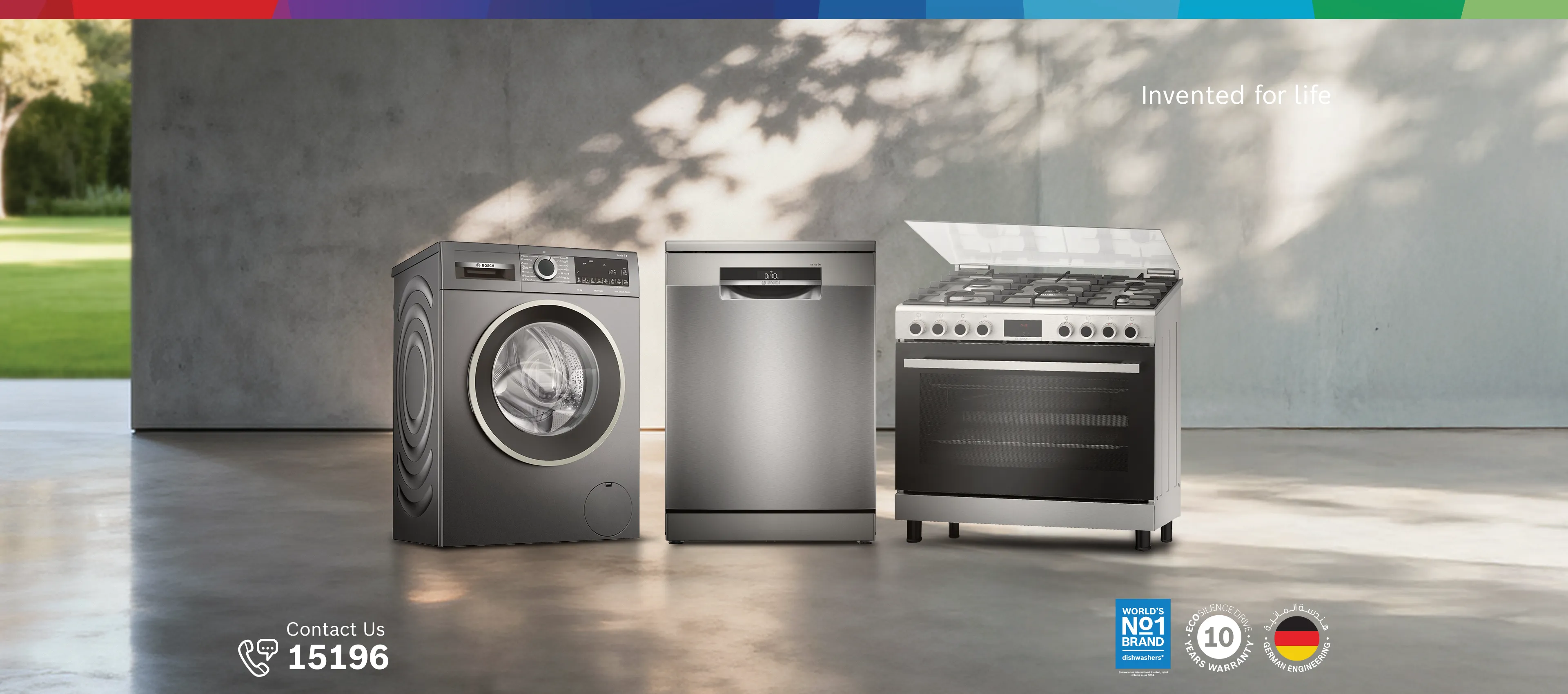 Bosch food processor with touch display surrounded by various fresh vegetables on a table.