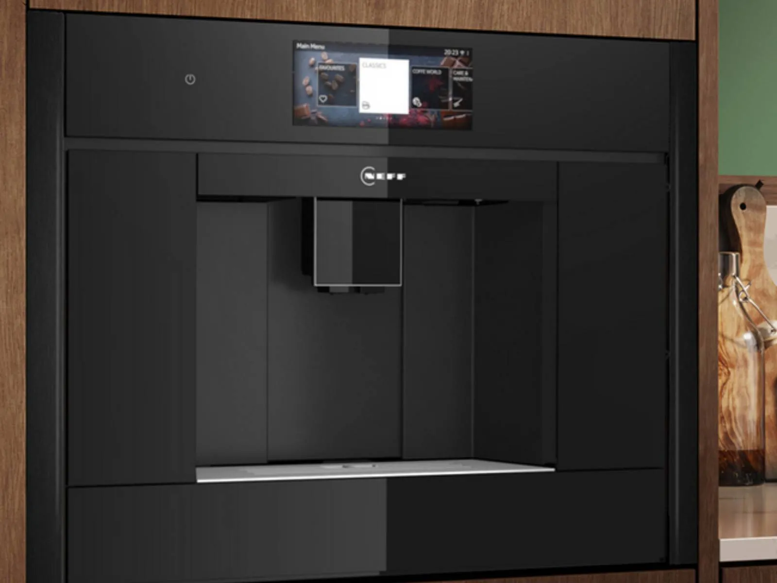 Black built in coffee machine set in dark wood cabinetry