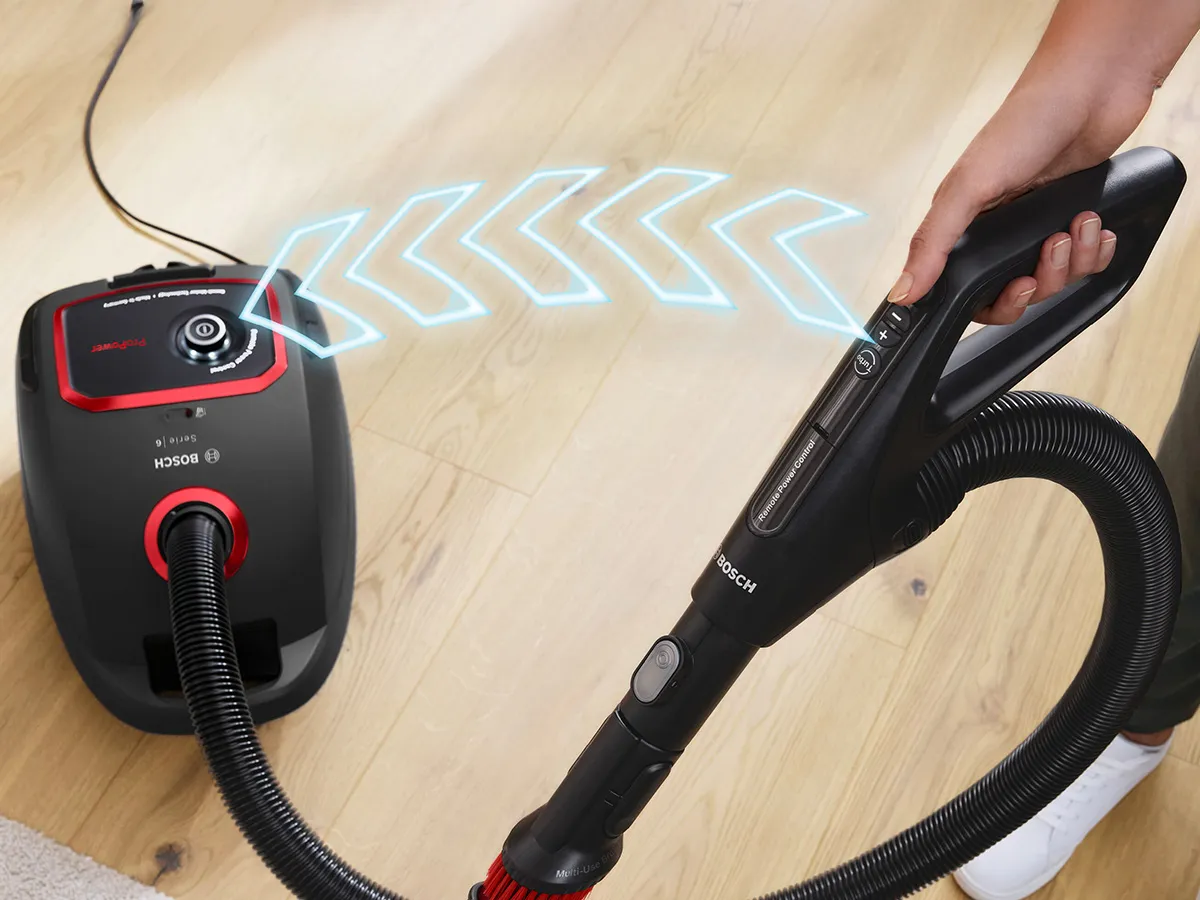 Bosch bagged series 6 model being used to clean a wooden floor.