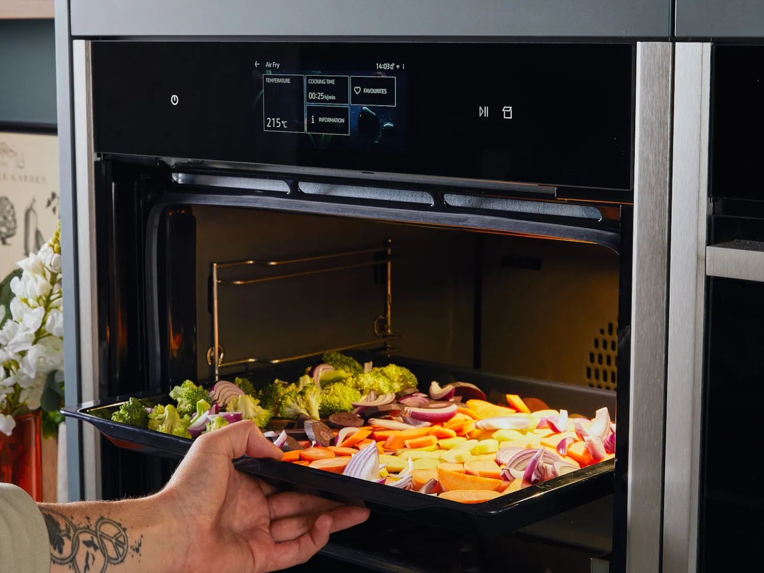 Tray with vegetable being put in oven tray