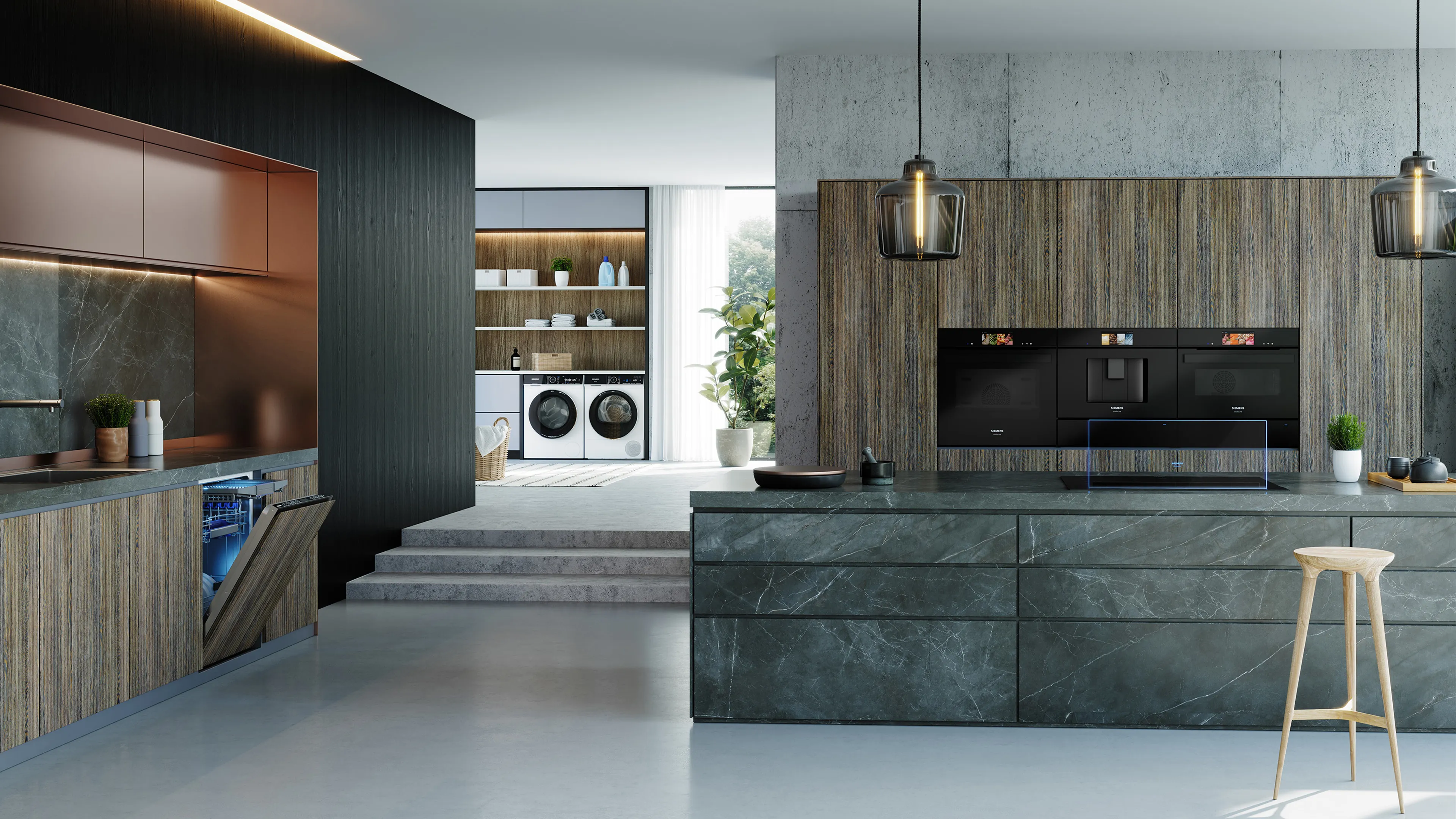 A luxurious, open-plan kitchen and laundry room featuring integrated Siemens appliances, including a dishwasher, oven, coffee machine, microwave, and stacked washer and dryer.