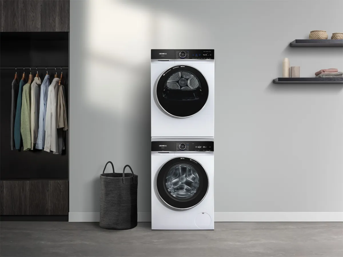 Stacked washing machines in neutral utility room