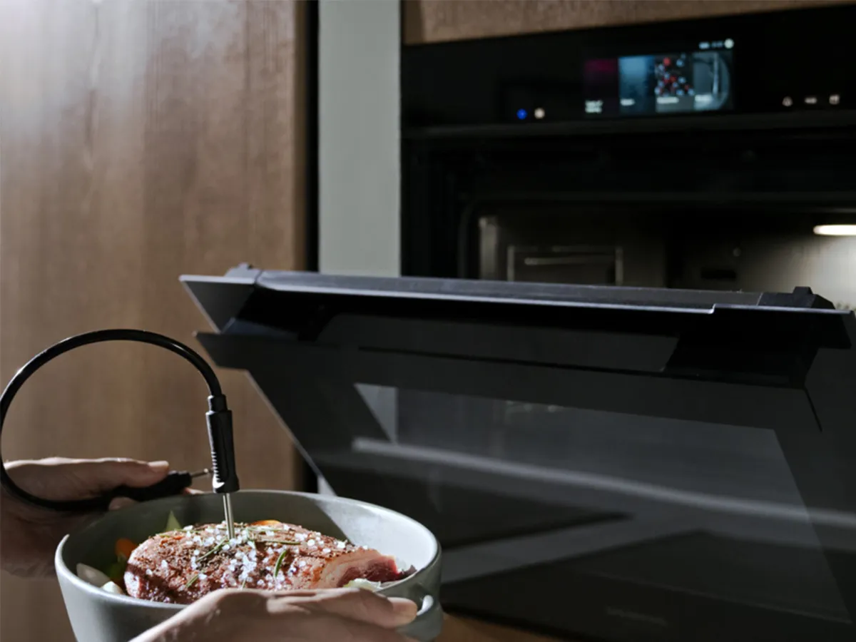 Roasted turkey on wooden cutting board, surrounded by kitchen utensils and ingredients.