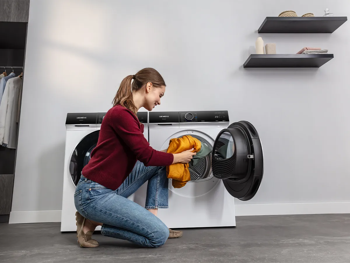 Person loading washing machine