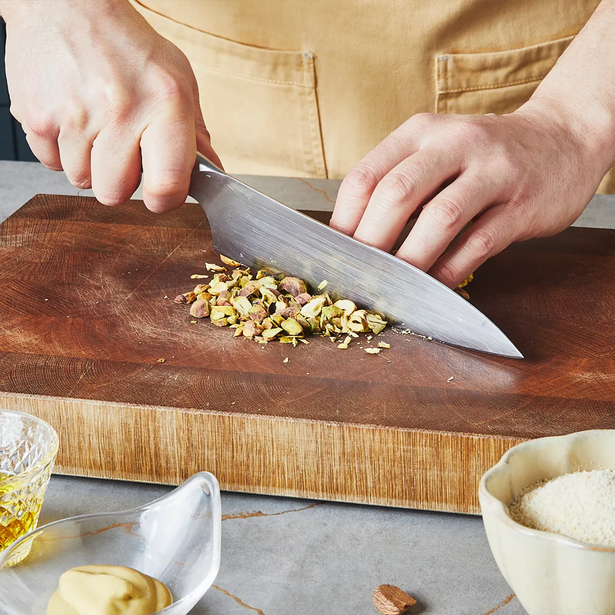 Chopping pistachios on a wooden board.