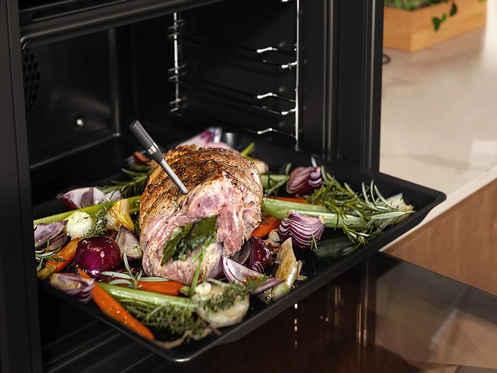 A tray holding a golden-brown roast, garnished with herbs, ready to be served.