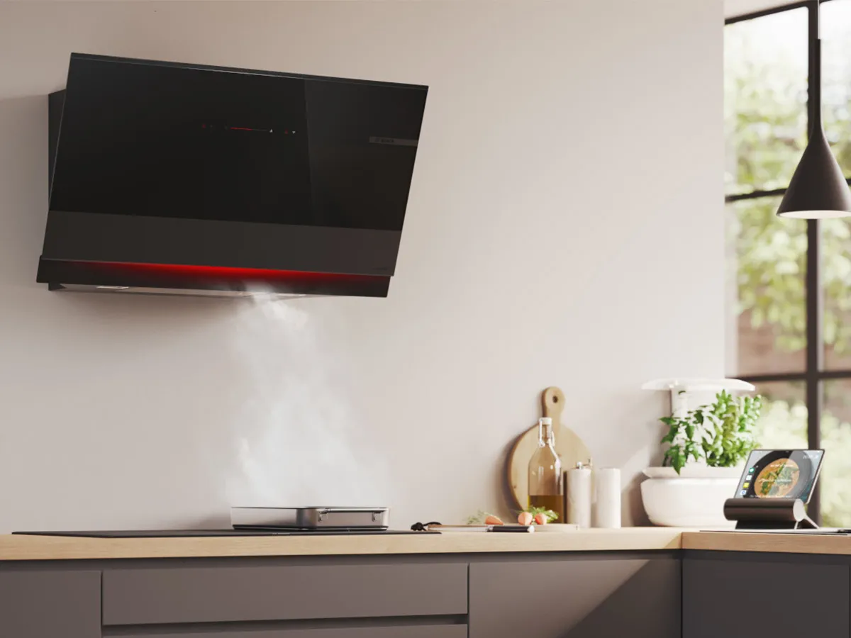 A black kitchen hood mounted above a cooktop, with a 90cm measuring scale displayed for reference.