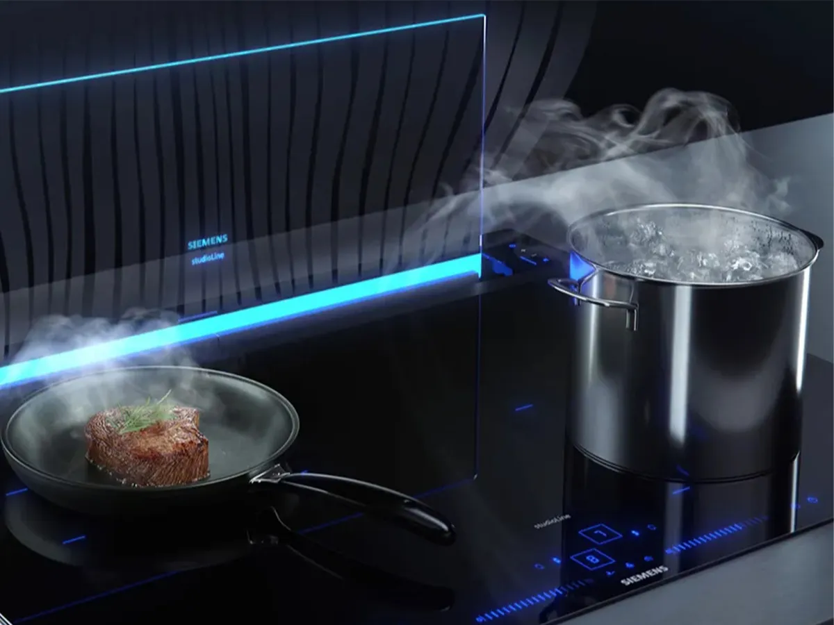 Siemens smart downdraft hob with food cooking on it