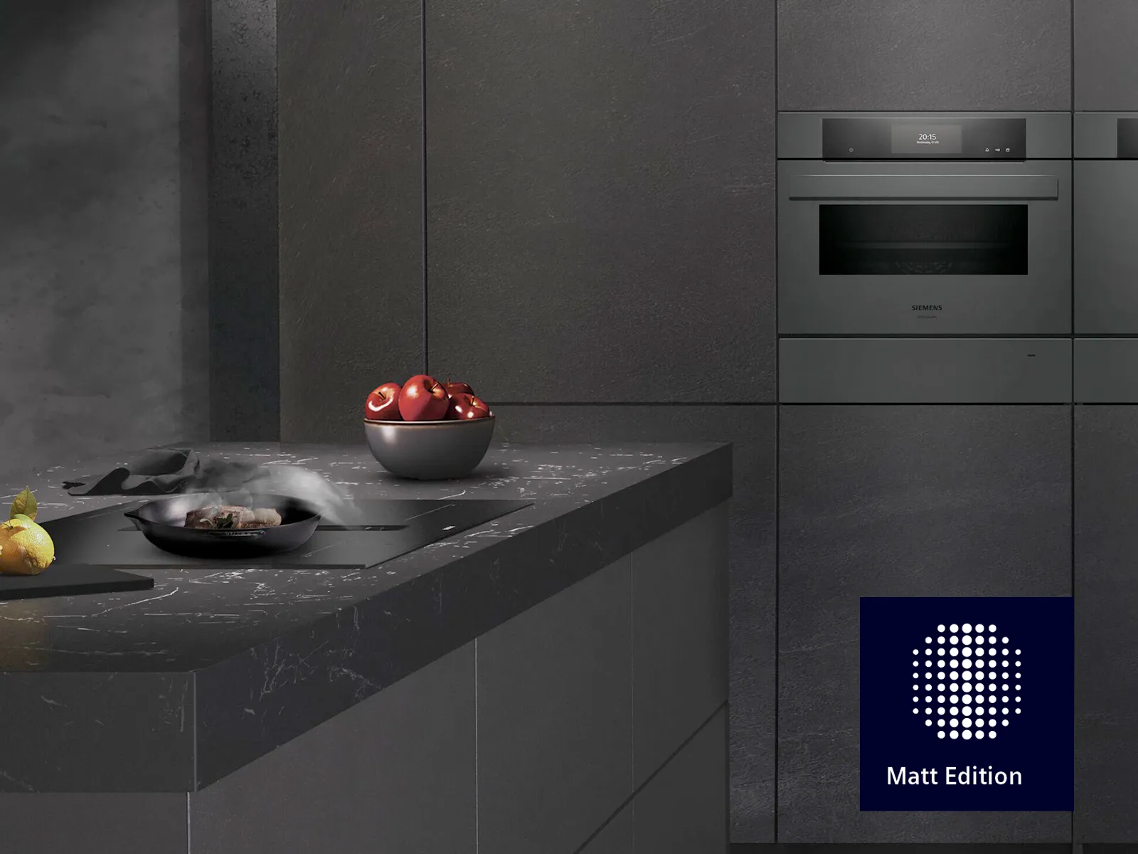 Eine elegante schwarze Küche zeigt modernes Design mit einem Kochfeld und einer dampfenden Pfanne, hervorgehoben durch eine Schüssel mit roten Äpfeln und einer leuchtenden Zitrone.