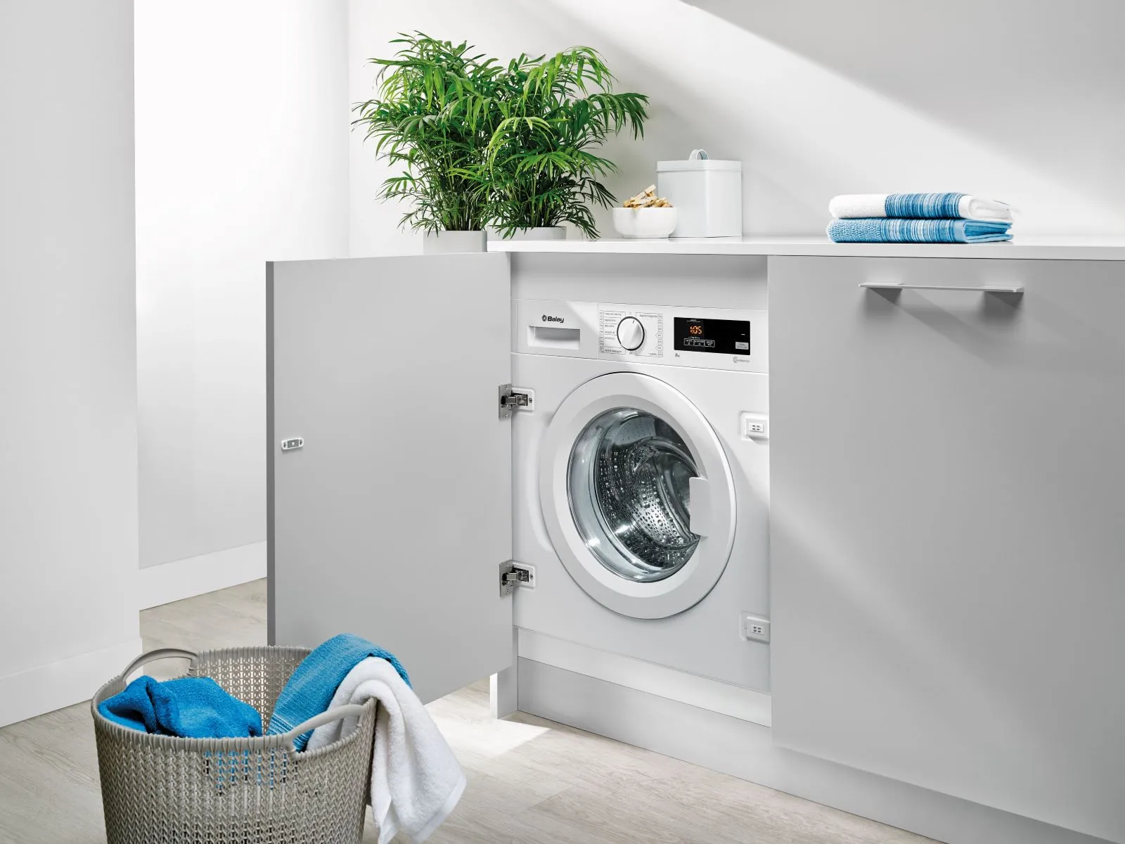 Máquina de lavar roupa integrável Balay instalada numa lavandaria branca.
