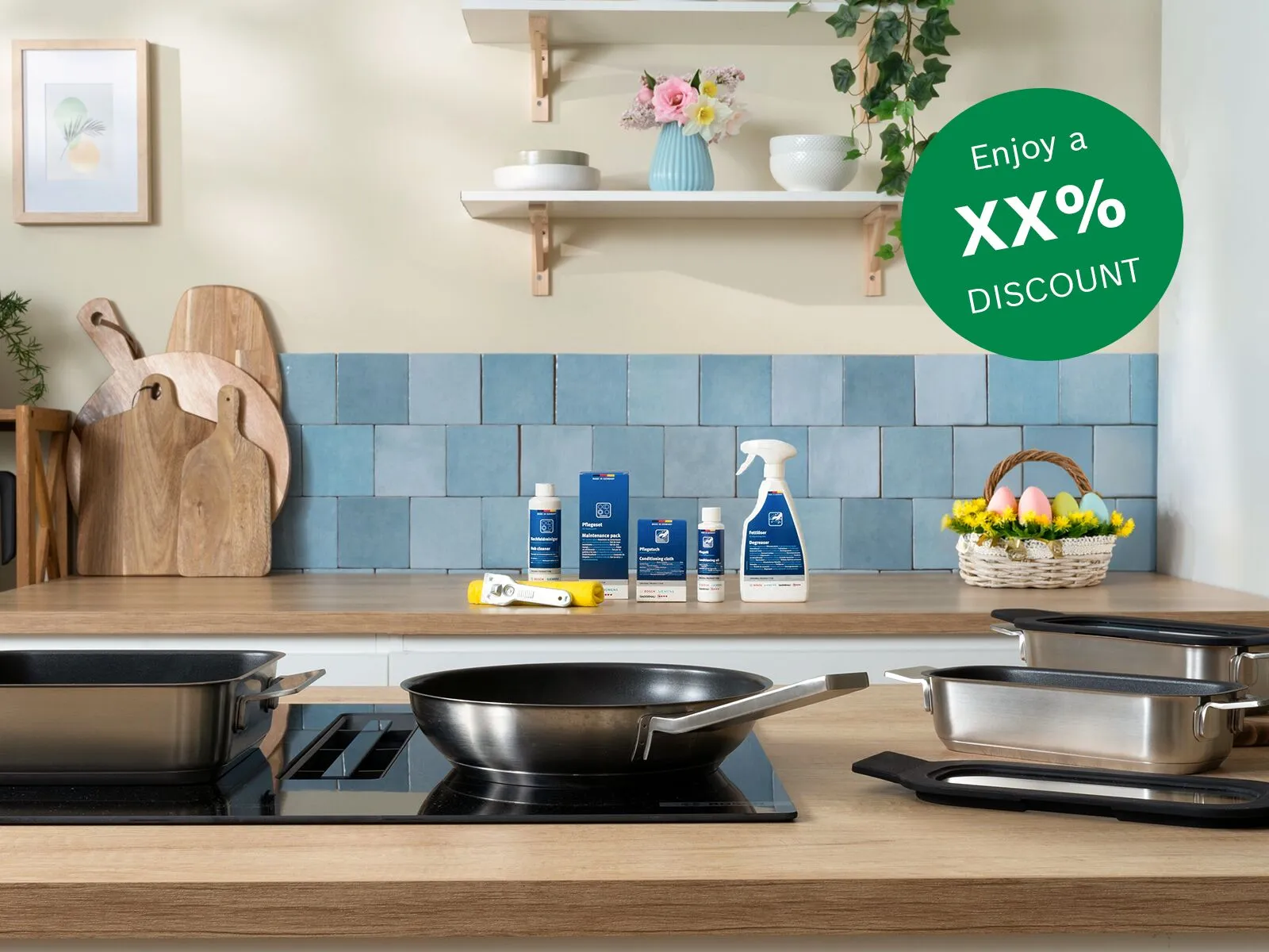 Modern kitchen countertop with stainless cookware on stovetop, blue tile backsplash, wood boards, potted plant, cleaners and an egg basket plus badge.