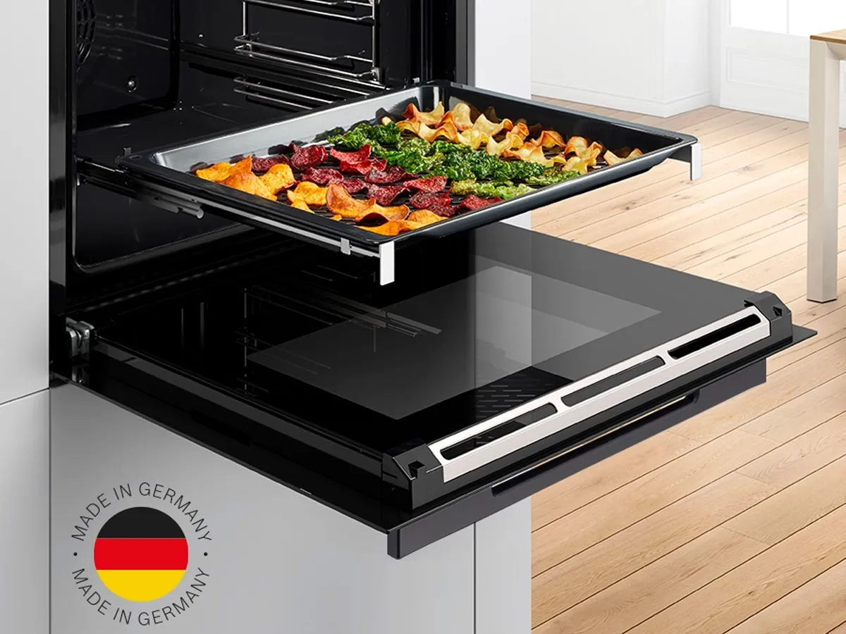 Black built-in microwave against a white kitchen wall.