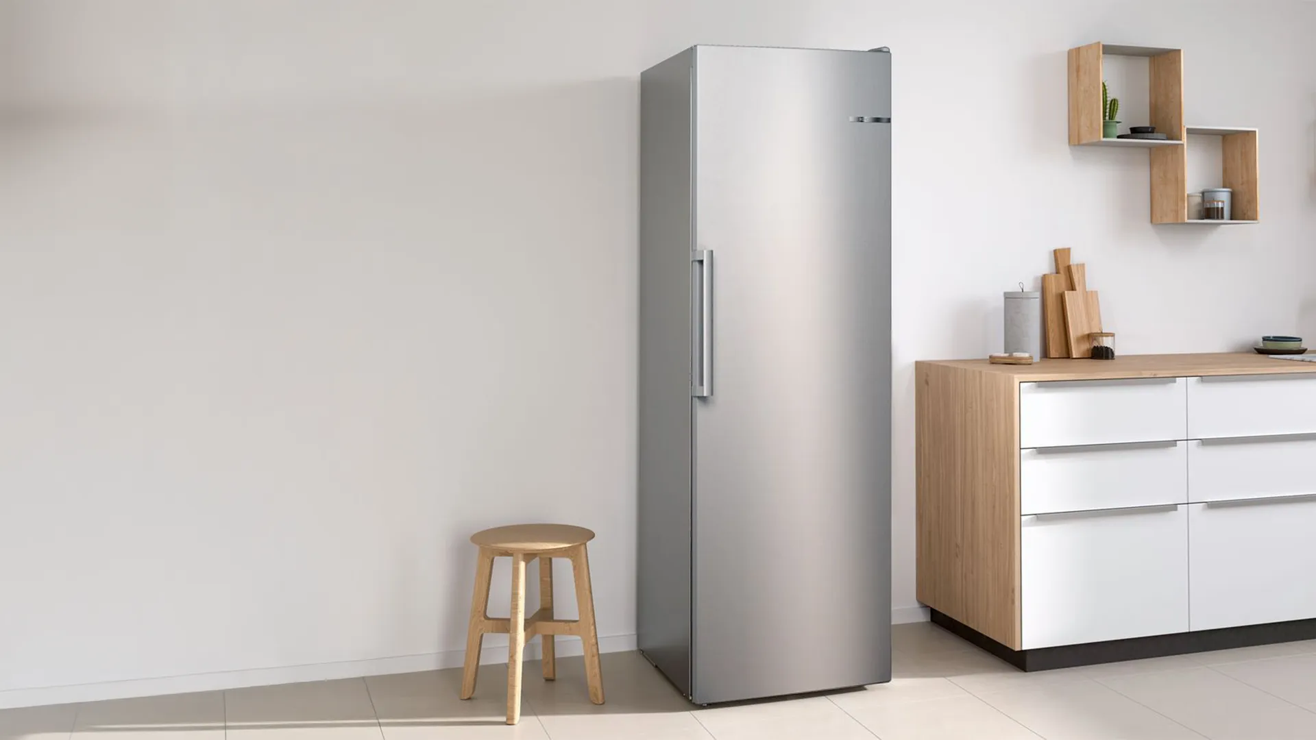 Open freestanding freezer in a bright, modern kitchen.