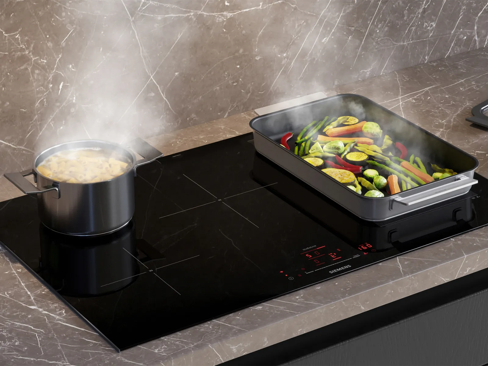 A black Siemens induction cooktop with a pot of steaming pasta and a large pan of colorful, steaming vegetables (carrots, zucchini, bell peppers, asparagus, Brussels sprouts) cooking on it. Red digital controls are visible.
