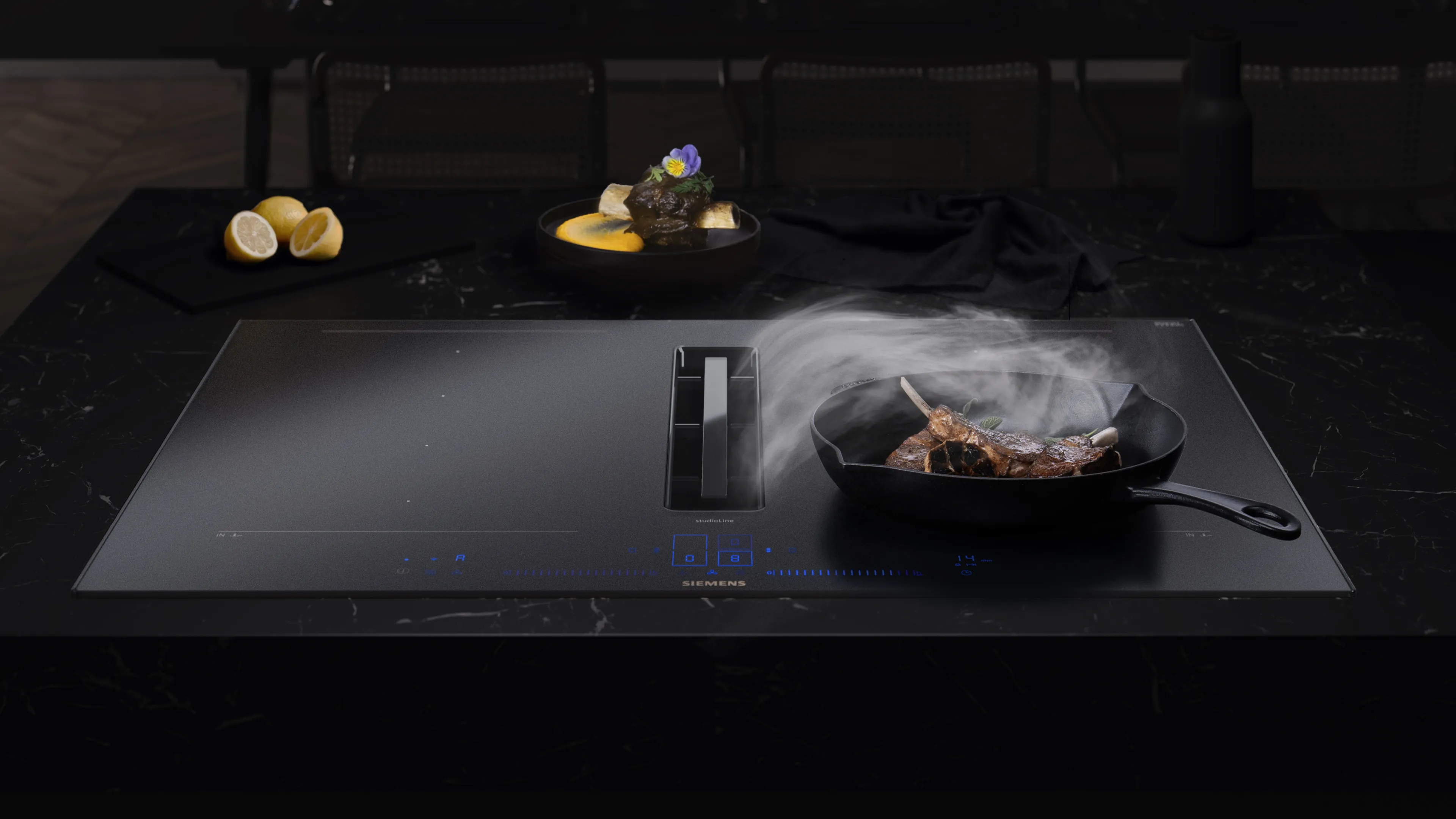 Matt black hobs with pan cooking and steam being extracted