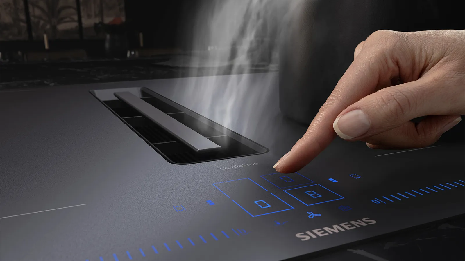 Hand using matt black hob display panel