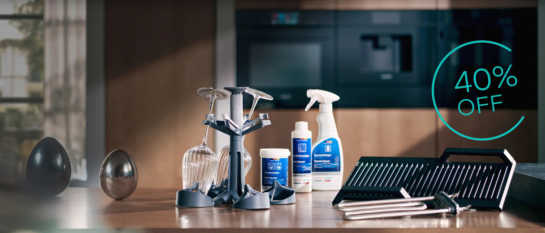 Display of kitchen cleaning products and utensils on a countertop, with a prominent "40% OFF" sale text in the corner.